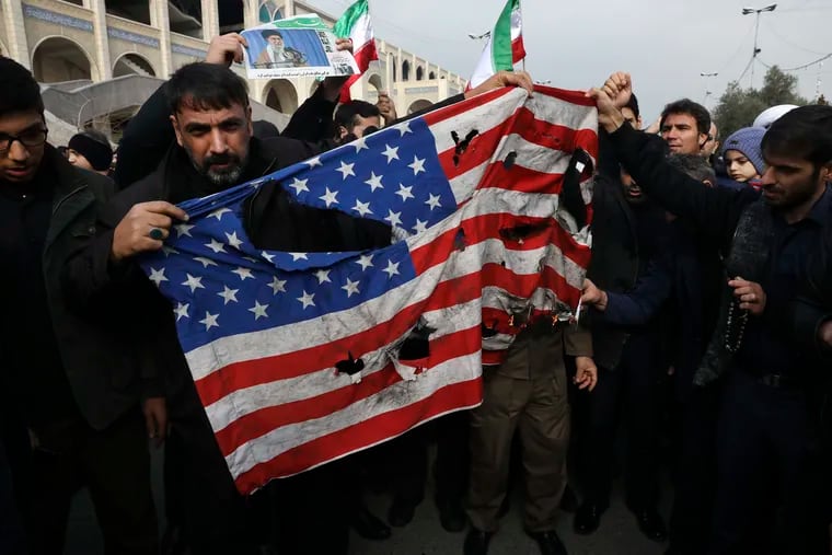 Protesters burn a U.S. flag Friday during a demonstration over the U.S. air strike in Iraq that killed Iranian Revolutionary Guard Gen. Qassem Soleimani, in Tehran.
