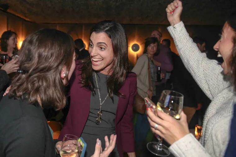 Democrat Rebecca Rhynhart (center), a campaign novice who held top posts in two city administrations before ousting Alan Butkovitz in the May primary, gets word of her victory Tuesday from campaign member Mara Kunin.
