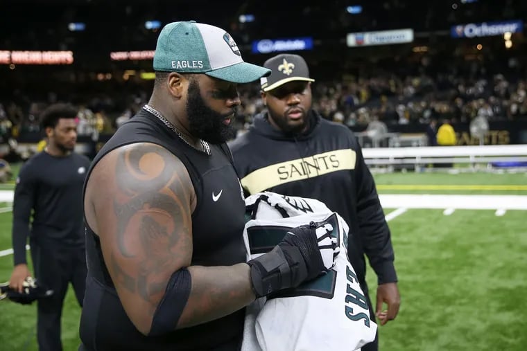 Eagles tackle Jason Peters, signing a jersey after their divisional-round playoff loss to the New Orleans Saints in January.