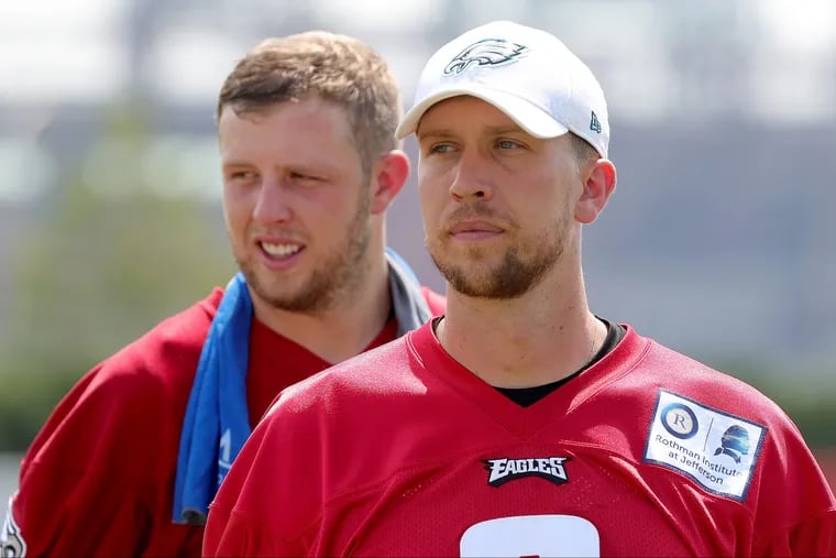 Eagles' Nate Sudfeld, left, and Nick Foles walks off the field after Eagles training camp at the NovaCare Complex in Philadelphia, PA on August 6, 2018. DAVID MAIALETTI / Staff Photographer