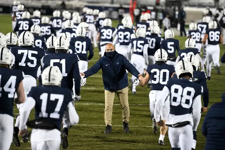 Penn State coach James Franklin greeting his players as they took the field for a game last December.