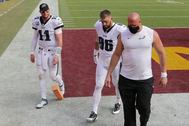 Eagles quarterback Carson Wentz (left) Eagles tight end Zach Ertz (center) and Eagles offensive tackle Lane Johnson (right) walk off the field after the game. Eagles lose 27-17 to the Washington Football Team at FedEx Field in Landover, MD on September 13, 2020.