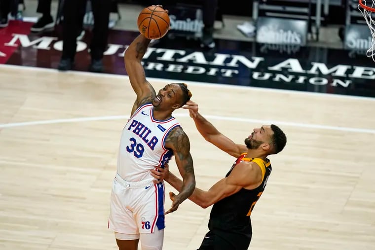 Sixers center Dwight Howard grabbing a pass as Utah Jazz center Rudy Gobert defends in the first half of Monday's game.