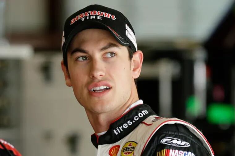 Joey Logano stands in the garage before driving practice laps in preparation for the NASCAR Nationwide Series' DuPont Pioneer 250 auto race, Friday, June 7, 2013, at Iowa Speedway in Newton, Iowa. (Charlie Neibergall/AP)