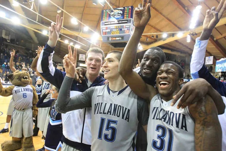 As a walk-on, Patrick Farrell (left) became a member of Villanova's second-ever team to win a national title in 2016. Here he's with former teammates (L-R) Ryan Arcidiacono, Daniel Ochefu, and Dylan Ennis as they celebrate a victory that season.