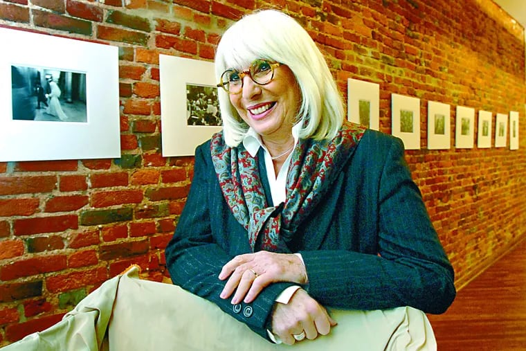 Ms. Wohlmuth poses at the Old City Jewish Art Center in 2009 with images of her show "Closed on Saturday," documenting Brooklyn Lubavitchers in the 1970s.