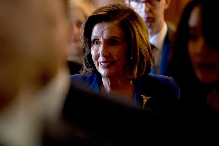 House Speaker Nancy Pelosi of Calif. walks to her office after signing the Coronavirus Aid, Relief, and Economic Security (CARES) Act on Friday.