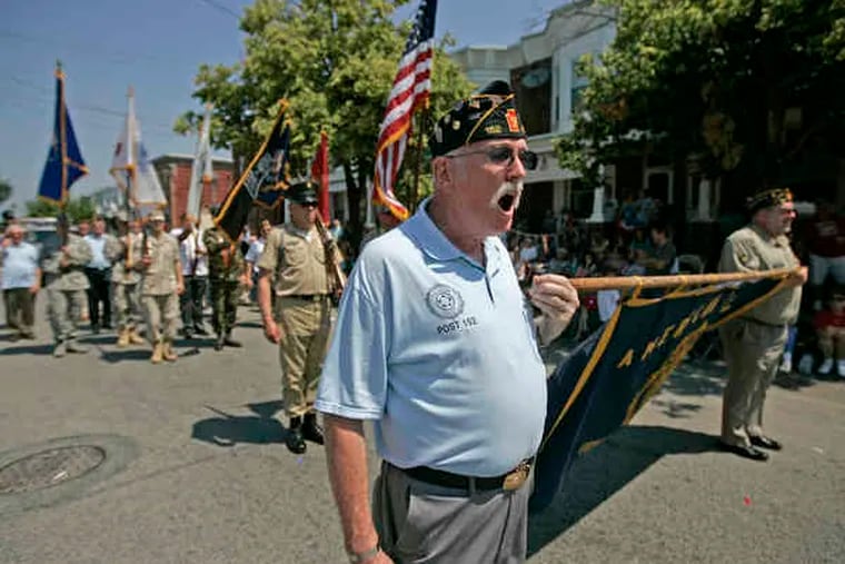 Jim Hockensmith of American Legion Post 152 of Port Richmond barks out commands to his fellow Legionnaires as they come before the reviewing stand at Richmond and Juniata Streets at the end of the Bridesburg parade.