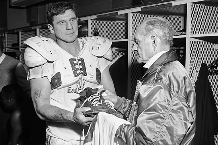 Chuck Bednarik of the Philadelphia Eagles hands his jersey and shoes
to equipment manager Freddie Schubach in St. Louis, Dec. 16, 1962
after game which the St. Louis Cardinals won 45-35. The game was
Bednarik's last. The jersey and the shoes will be placed in the
Football Hall of Fame. (AP Photo)