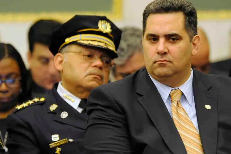 Police Commissioner Charles H. Ramsey , joined by Managing Director Richard Negrin, listens to the mayor's presentation.