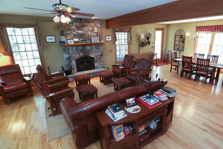 The living room and dining room of the Cottones' Lake Wallenpaupack vacation house. STEVEN M. FALK / Staff Photographer
