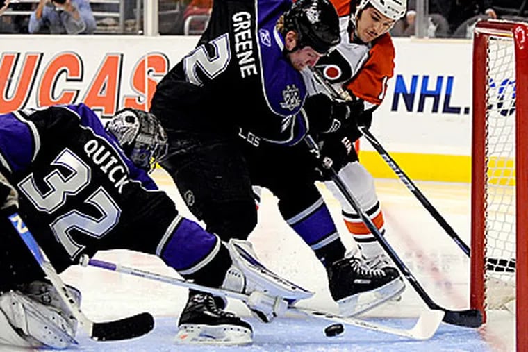 Los Angeles Kings goalie Jonathan Quick, left, tries to stop a shot by Philadelphia Flyers left wing Daniel Carcillo, right, as  Kings' Matt Greene defends during the first period.  (AP Photo/Mark J. Terrill)