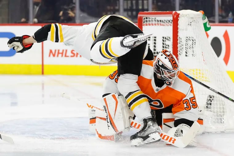 Boston Bruins left wing Nick Foligno goes after the puck over Flyers goaltender Martin Jones during the second period on Saturday, November 20, 2021 in Philadelphia.