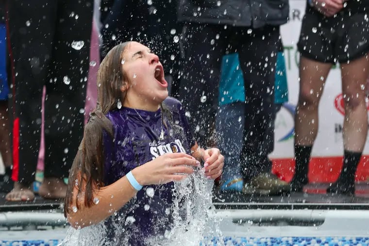 Payton Conaway of Upper Darby High School reacts after jumping into the pool.