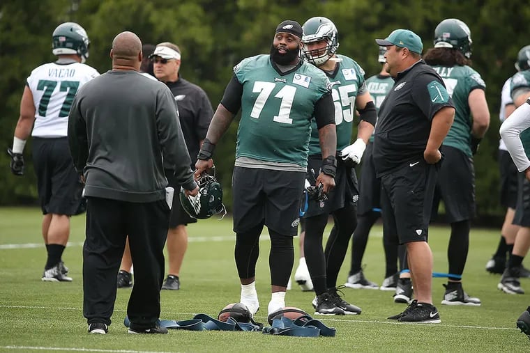 Jason Peters talks to his coaches during practice.