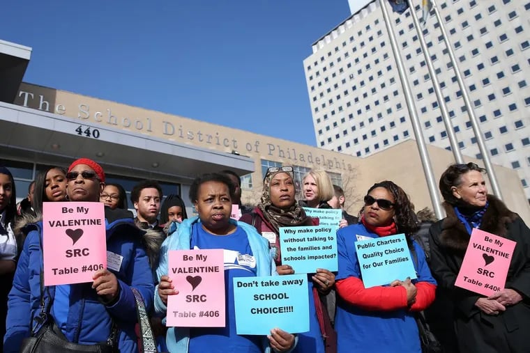 A group representing 87 charter schools has sued the Philadelphia School District over a policy it says will hamper charter operations. In this file photo, protesters railed against the policy.