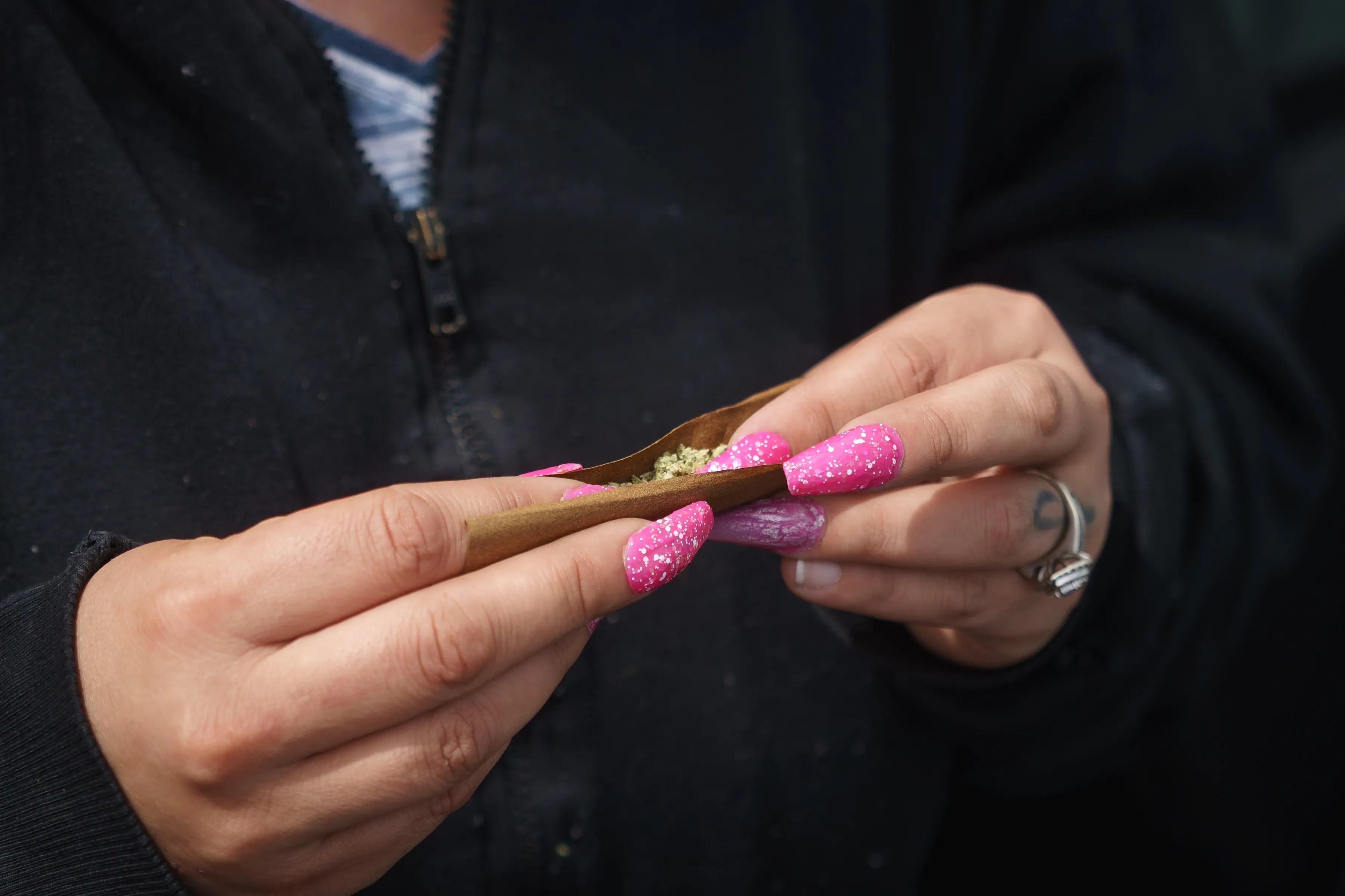 Dionne Finley rolls newly purchased flower, part of the cannabis plant, in Williamstown, on the first day of recreational cannabis sales in New Jersey.