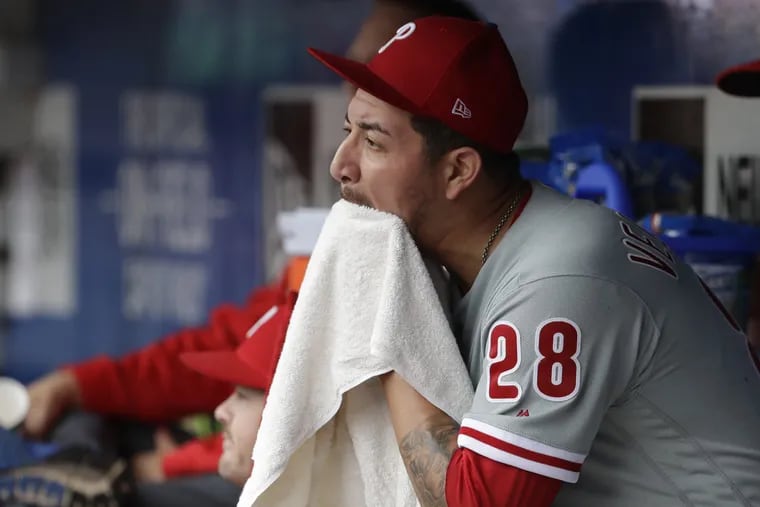 Phillies pitcher Vince Velasquez sits in the visiting dugout at Citi Field Sunday after giving up four runs in the bottom of the fifth inning during a loss to the New York Mets.