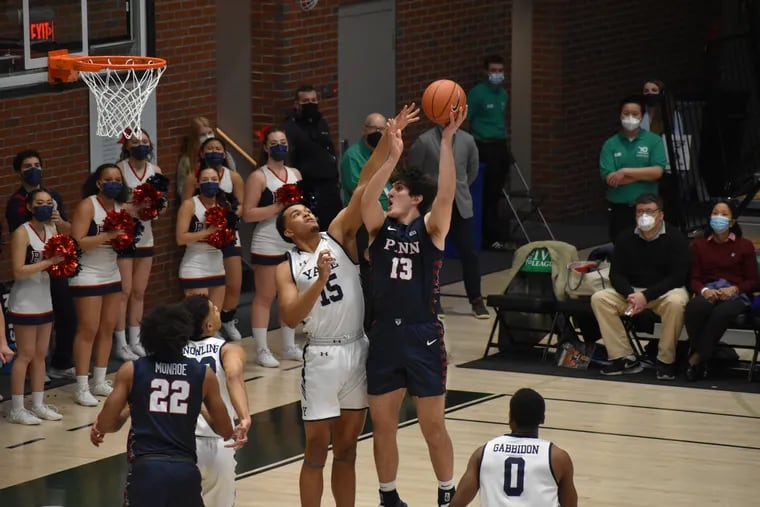 Penn's Nick Spinoso (13) goes up for a shot during the first half.