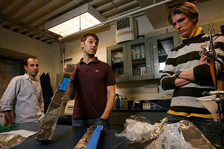 With core samples of muck used for their study of sea levels are Penn professor Benjamin P. Horton (center) and postdoctoral researchers Andrew C. Kemp (left) and Simon E. Engelhart (right). ( MICHAEL S. WIRTZ / Staff Photographer )