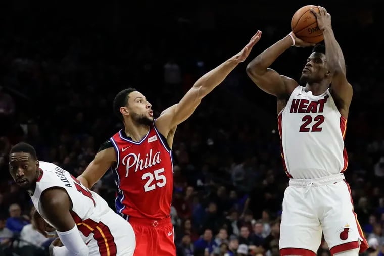 Sixers guard Ben Simmons defends Miami Heat forward Jimmy Butler past center Bam Adebayo during the third-quarter on Saturday, November 23, 2019 in Philadelphia.  Butler missed the shot attempt.