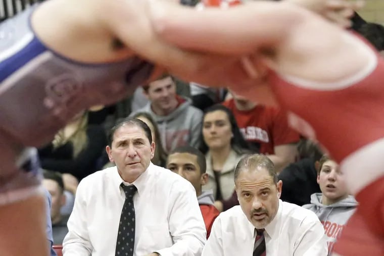 Paulsboro High School wrestling coach Paul Morina (left) led the Red Raiders to their 31st state title on Sunday.