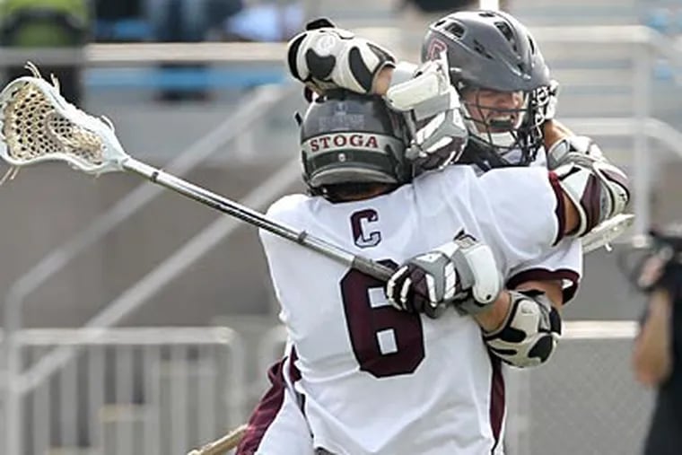 Tanner Scott and Billy Flatley celebrate after a second quarter goal for Conestoga. (Charles
Fox/Staff Photographer)