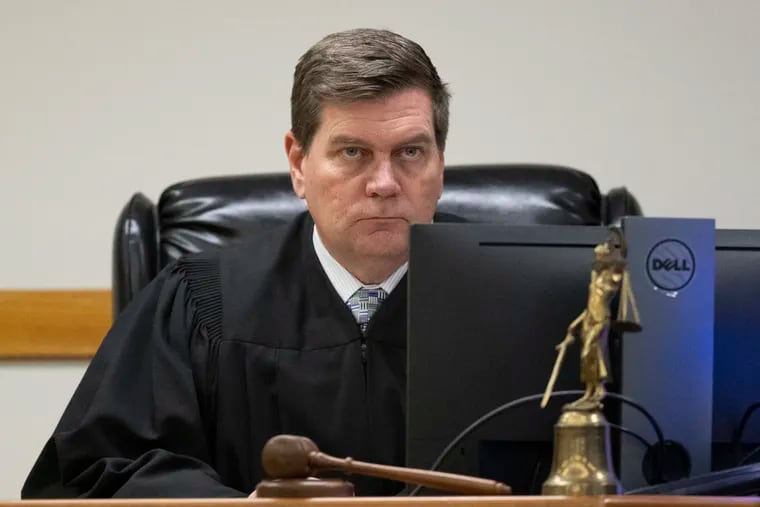 Superior Court Judge John Kennedy listening to arguments at a January hearing to decide if the case against Wasim Muhammad would proceed to trial. On Monday, Kennedy delayed the trial to allow the defense additional time to respond to newly raised legal arguments about the defense strategy.