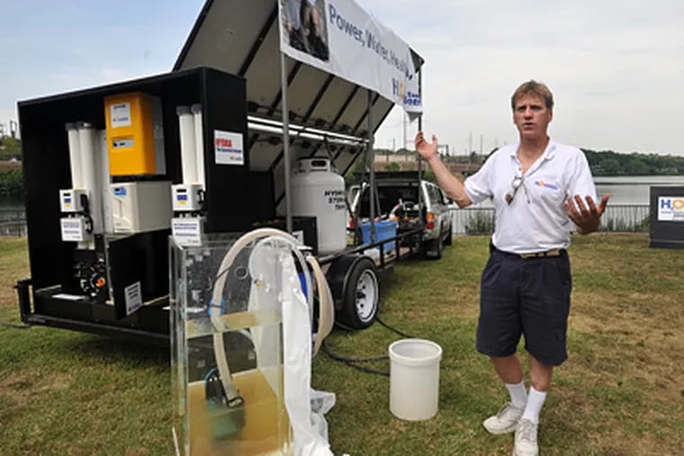 David Squires, CFO, of The Essential Element, explains the solar generated water filtration system, called the Hydra, on display along the banks of the Schuylkill River in Philadelphia. ( Sharon Gekoski-Kimmel / Staff Photographer )