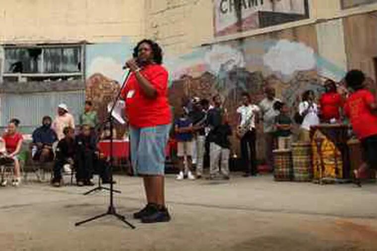 Ronsha Dickerson speaks at a rally at the Unity Community Center, aimed at releasing the property from a tax lien.