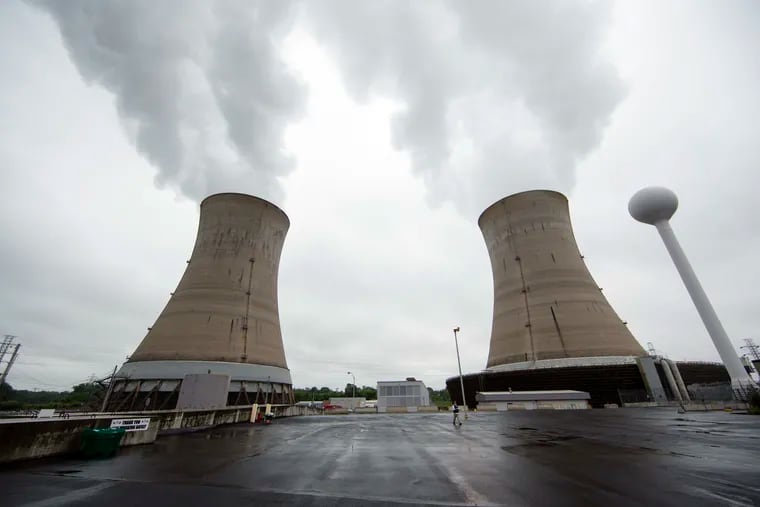 FILE - This May 22, 2017 file photo, shows cooling towers at the Three Mile Island nuclear power plant in Middletown, Pa. The Nuclear Regulatory Commission staff is recommending that the agency cut back on inspections at the country's nuclear reactors, a cost-cutting move promoted by the nuclear power industry but denounced by opponents as a threat to public safety. Exelon Corp., the owner of Three Mile Island, site of the United States' worst commercial nuclear power accident, said it will shut down the plant in 2019 without a financial rescue from Pennsylvania.