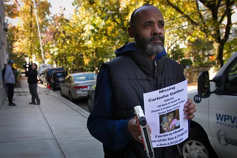 Carl Freeland, father of Carlesha Gaither of Germantown, holds a flyer with information on his missing daughter abducted from W. Coulter St at Greene St. on Sunday, November 2, 2014. ( ALEJANDRO A. ALVAREZ / STAFF PHOTOGRAPHER )
