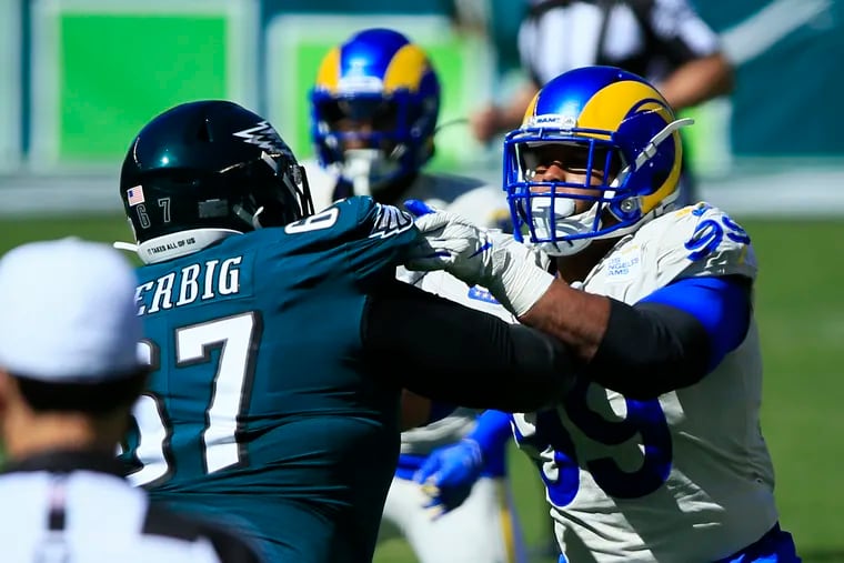 Nate Herbig jousts with Rams defensive tackle Aaron Donald last Sunday.