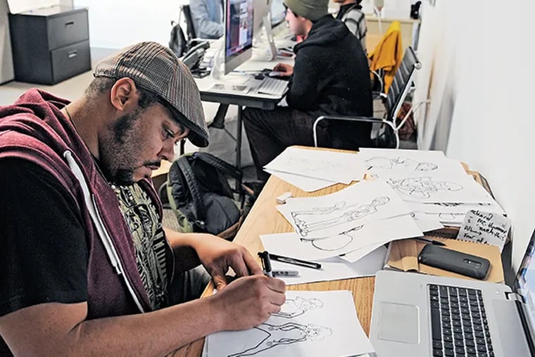Michael White, 34, political cartoonist for the internet site OogeeWoogee, which is dedicated to the positive viewpoint of the global phenomenon of the hip-hop lifestyle, in the newsroom of the Bala Cynwyd office Dec. 1, 2014.  (Clem Murray / Staff Photographer)