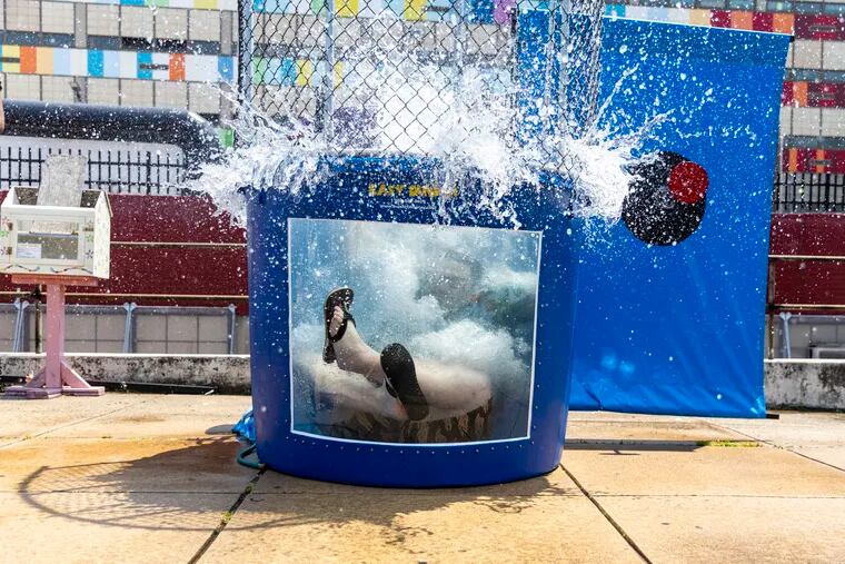 Vice Principal Joe Tabasco falls into the dunk tank during South Philadelphia High School's Rams' Day Fair, when the temperature hit a high of 94. “The more fun the kids have, the better behaved they are,” Tabasco said.