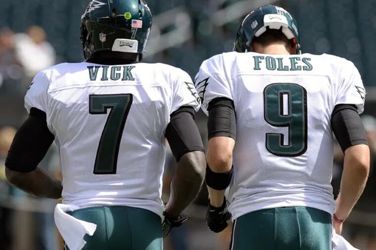 Eagles quarterbacks Michael Vick and Nick Foles. (Michael Perez/AP)