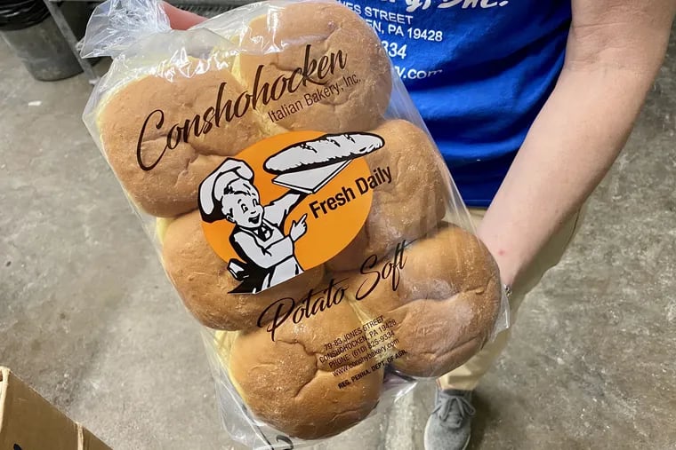 Tina Gambone holding a dozen potato rolls at Conshohocken Italian Bakery. Potato rolls account for about 20% of the bakery's sales.