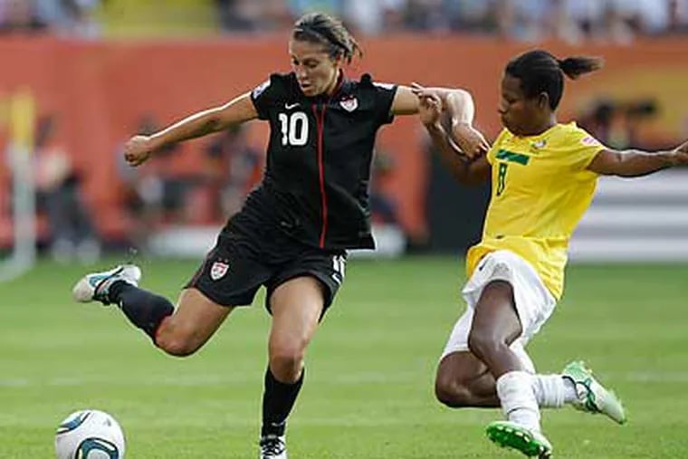 Carli Lloyd (left) is one of several players on the U.S. women's team with local connections. (Marcio Jose Sanchez/AP)