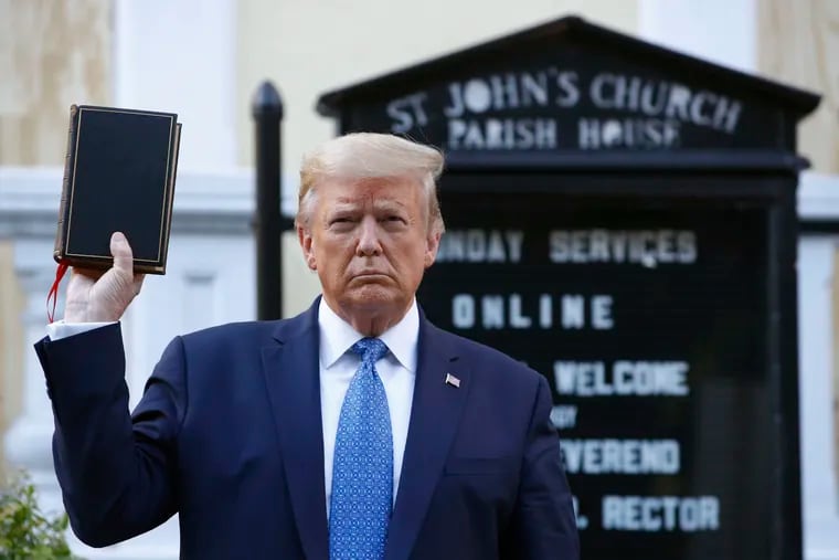 Donald Trump holds a Bible as he visits outside St. John's Church, across from Lafayette Square and the White House, in 2020. The former president spent Easter attacking his perceived enemies on social media.