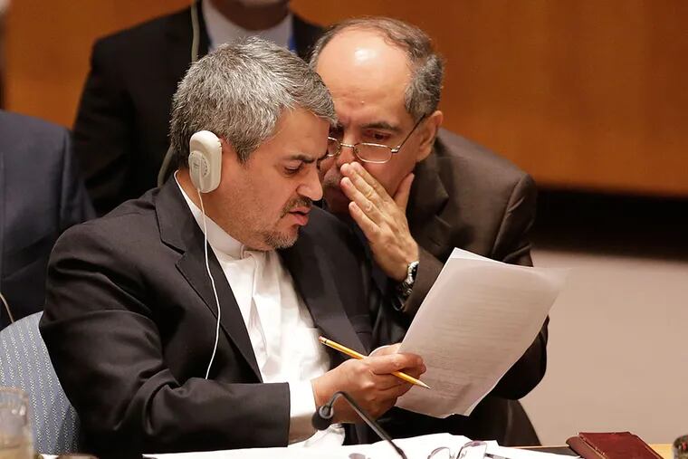 Iranian diplomats confer last week at the U.N., which gave its support to the nuclear pact last week. MARK LENNIHAN / AP