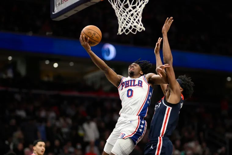 Philadelphia 76ers guard Tyrese Maxey (0) goes to the basket against Washington Wizards guard Bilal Coulibaly, right, during the second half on Saturday.
