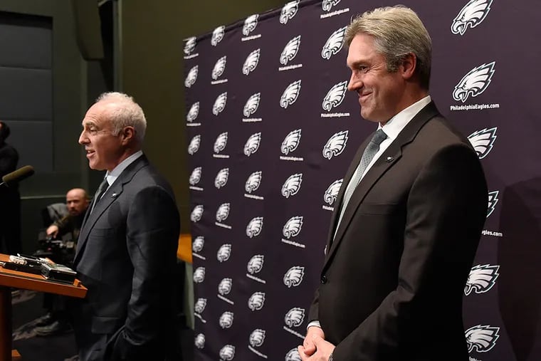 Doug Pederson (right) laughs as owner Jeffrey Lurie makes a joke during a press conference.