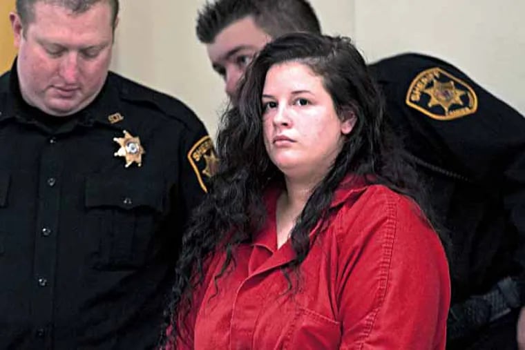 Paige Pfeffele, a LaSalle University student from Audubon Park, is ushered in by offers to her her sentence for killing her boyfriend in 2010. November 15, 2013 ( RON TARVER / Staff Photographer )