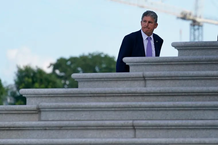 Sen. Joe Manchin (D., W.Va.) walks up the steps of Capitol Hill in Washington on Monday.