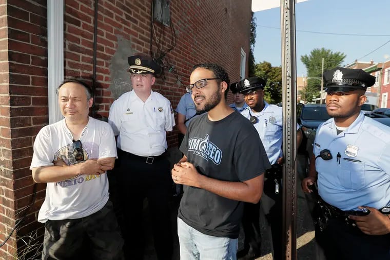 Henry Nhu, (let) Police Captain John Walker, By Grace Alone Church Pastor Gabriel Wang-Herrera, Police Officers Joseph Ball and Naeem Crawley on the 800 block of Griscom St. in the Frankford section of Philadelphia.