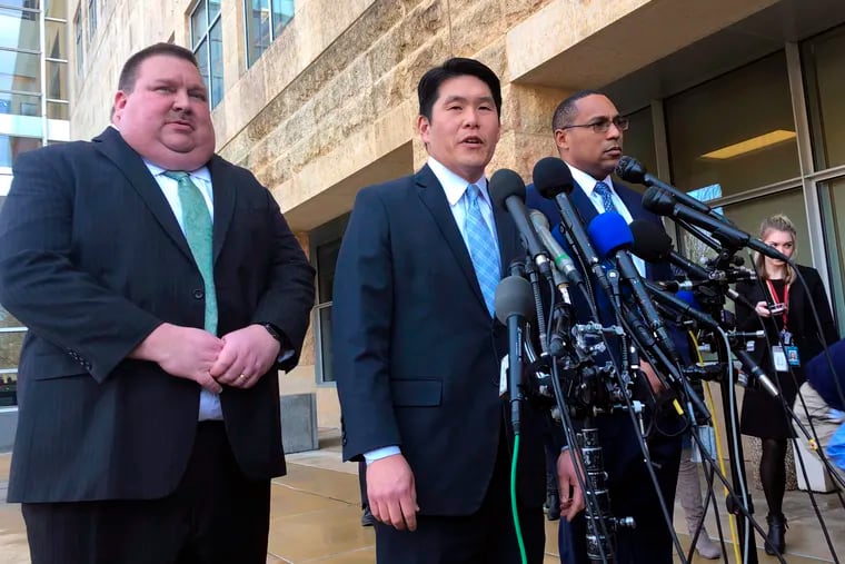 FILE - In this Feb. 21, 2019, file photo, U.S. Attorney Robert Hur (center) of the District of Maryland speaks as Art Walker (left), special agent from the Coast Guard investigative service, and Gordon Johnson, special agent in charge of the FBI's Baltimore office, listen during a news conference about Coast Guard Lt. Christopher Paul Hasson, outside the federal courthouse in Greenbelt. Hasson, accused of stockpiling guns and compiling a hit list of prominent Democrats and network TV journalists, pleaded not guilty on Monday, March 11, 2019, to drug and firearms charges. An attorney for Hasson, 49, entered the plea on his behalf at an arraignment on charges of illegal possession of firearm silencers, possession of firearms by a drug addict and unlawful user, and possession of a controlled substance.