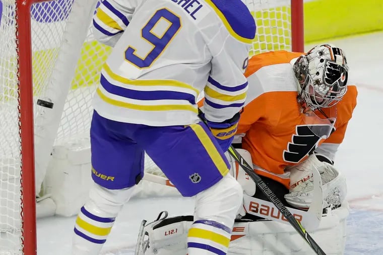 It's been a shooting gallery in front of the Flyers' goalies in the season's first five games. In this photo, Buffalo center Jack Eichel watches Sam Reinhart's shot get past Flyers goaltender Carter Hart on Monday.