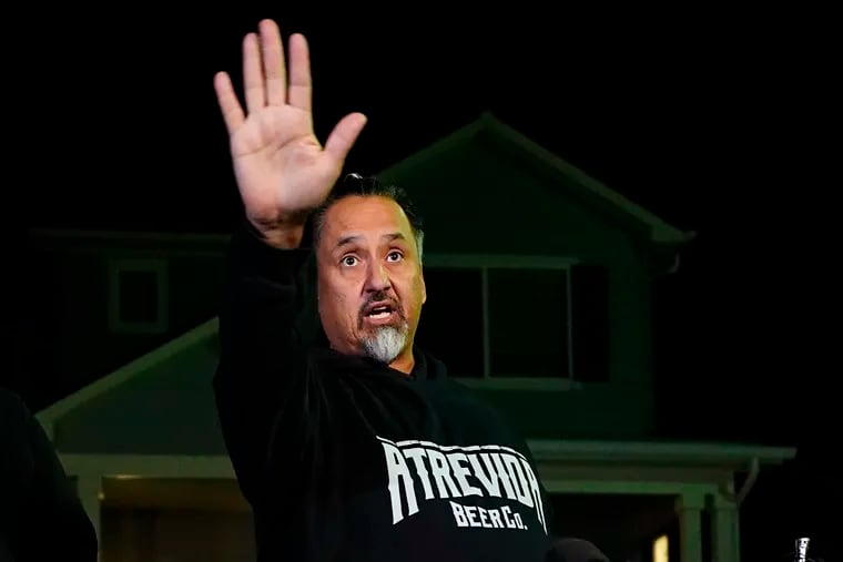 Richard Fierro gestures while speaking during a news conference outside his home about his efforts to subdue the gunman in Saturday's shooting at Club Q.