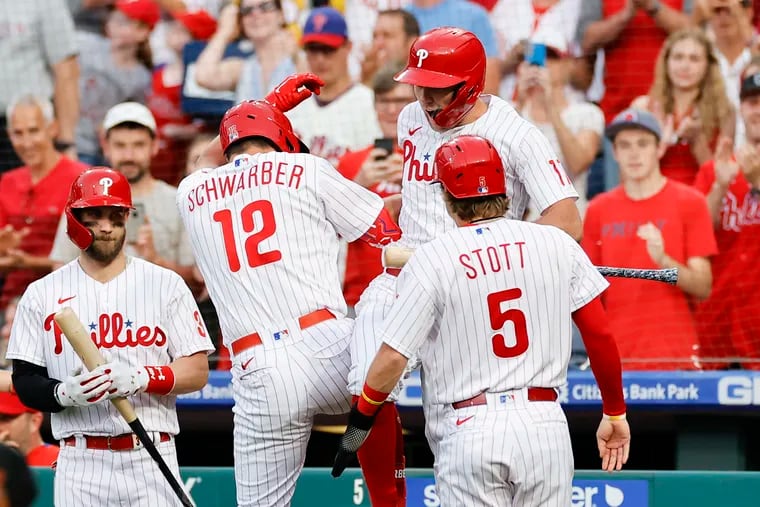 Kyle Schwarber celebrates his second-inning three-run home run with teammate Rhys Hoskins.