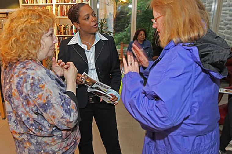 Democratic candidate for City Council Cindy Bass, center, interacts with voters and committepeople outside the Chestnut Hill Library  polling area Tuesday just before polls closed at 8 p.m. (Michael Bryant /
Staff Photographer)